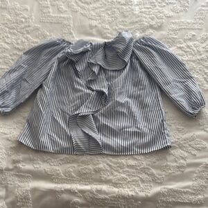Woman’s light blue striped blouse with bow in the front